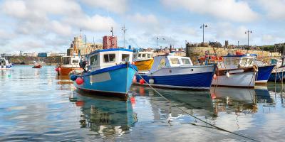 Harbour with a collection of blue and yellow fishing boats