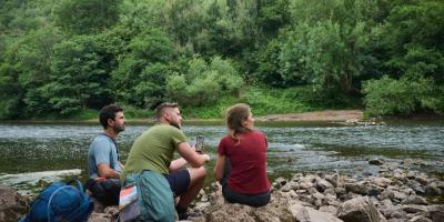 People sat next to a river
