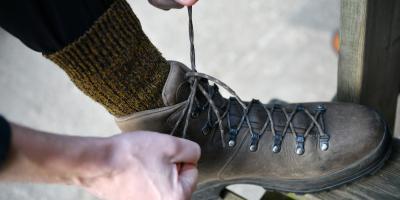 Person lacing up walking boots