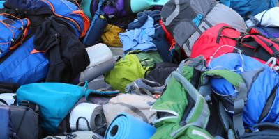 Pile of backpacks and sleeping matts 