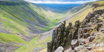 Rocky valley landscape with jagged rocks in the foreground