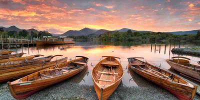 Row of wooden rowing boats on a lake shore
