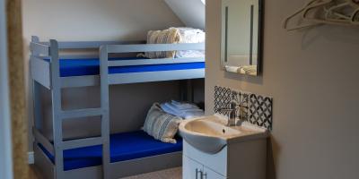 Bedroom with bunk beds and sink