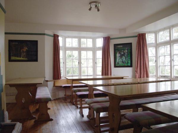 Dining room with large wooden tables and bench seating