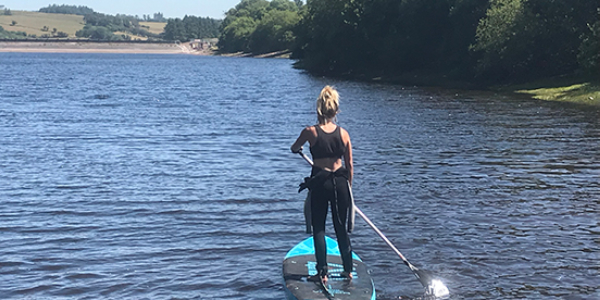 Paddle boarding on a river