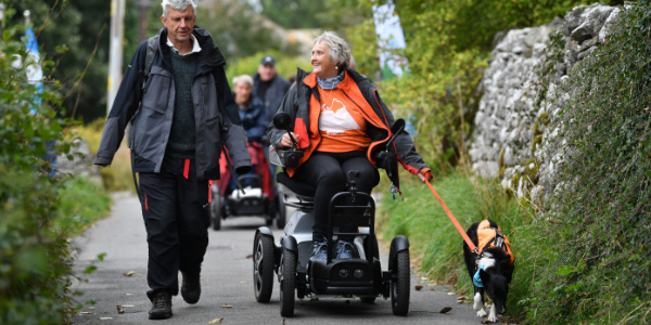 Two people and a dog taking part in accessible walk from YHA Malham
