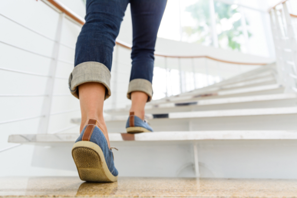 Close up of legs walking upstairs