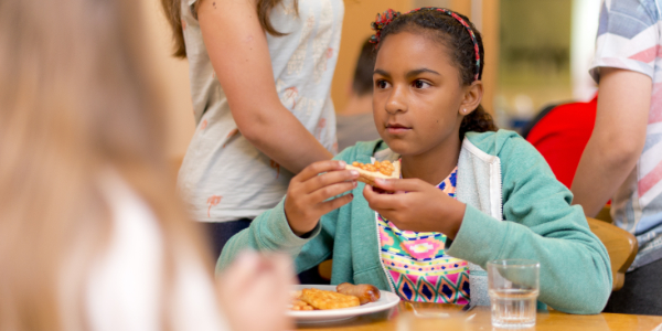 Child eating cooked full English breakfast