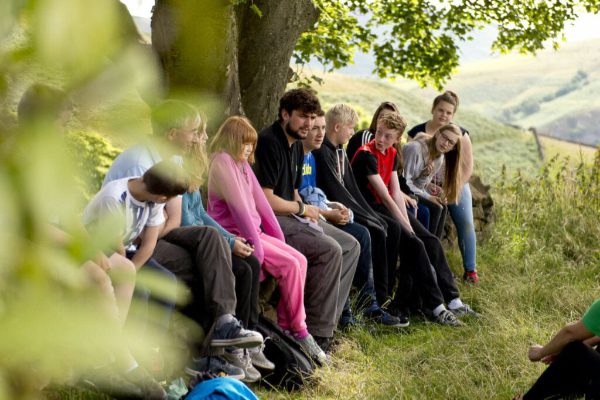 Group of young people and YHA leader in countryside