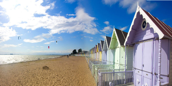 Multi-coloured beach huts on a beach