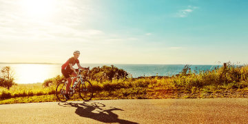 Cyclist cycling alone the coast