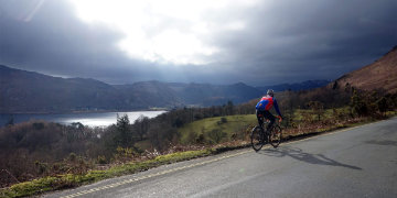 Road cyclist cycling through the lake district
