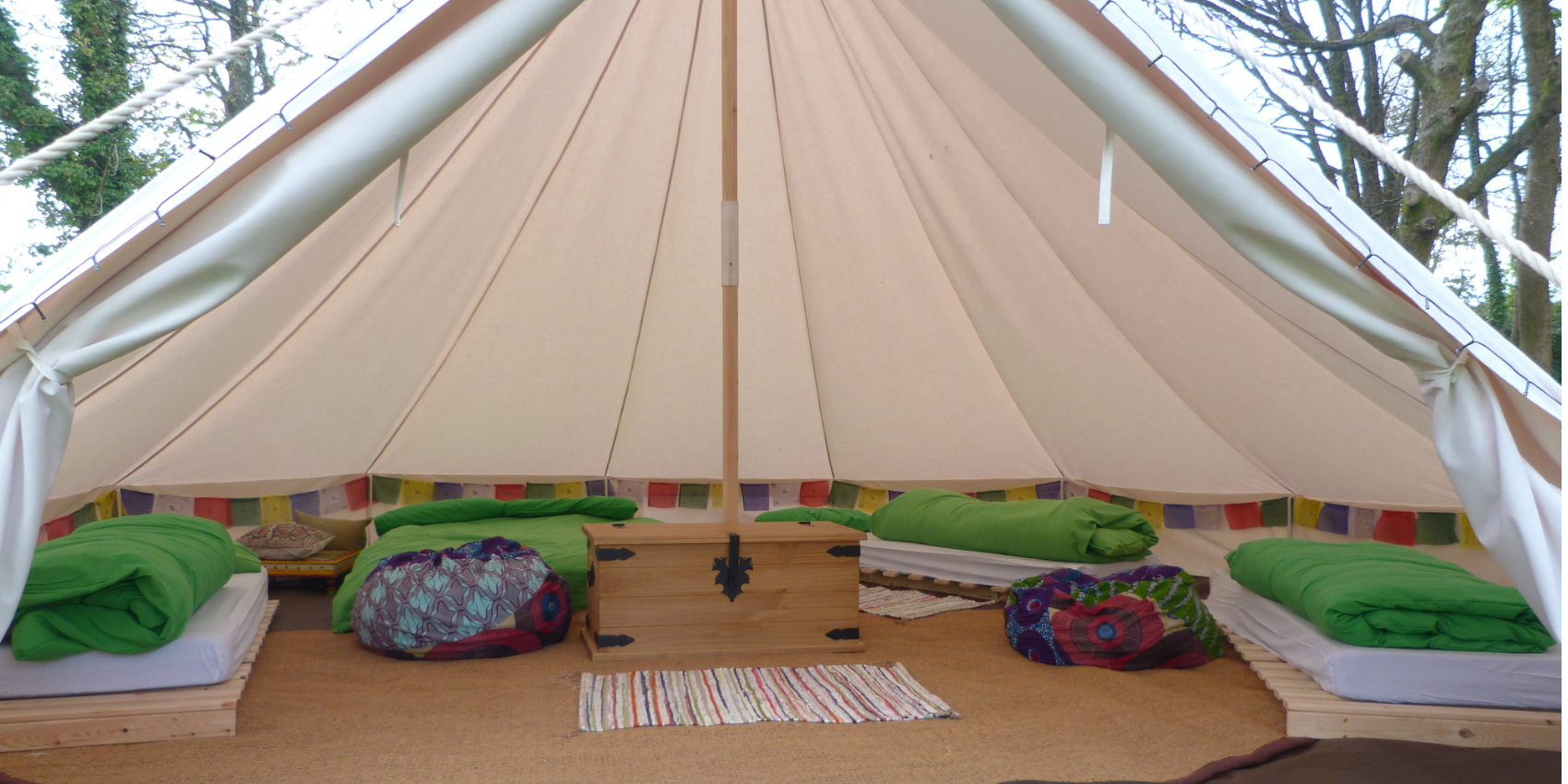 Bell tents with green cushions