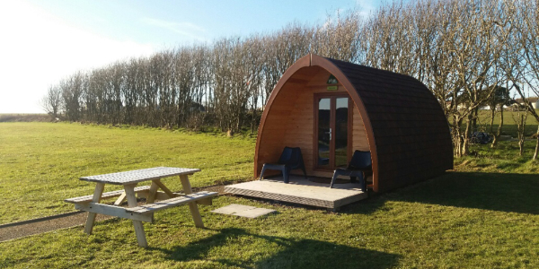 Camping pod in a field in autumn