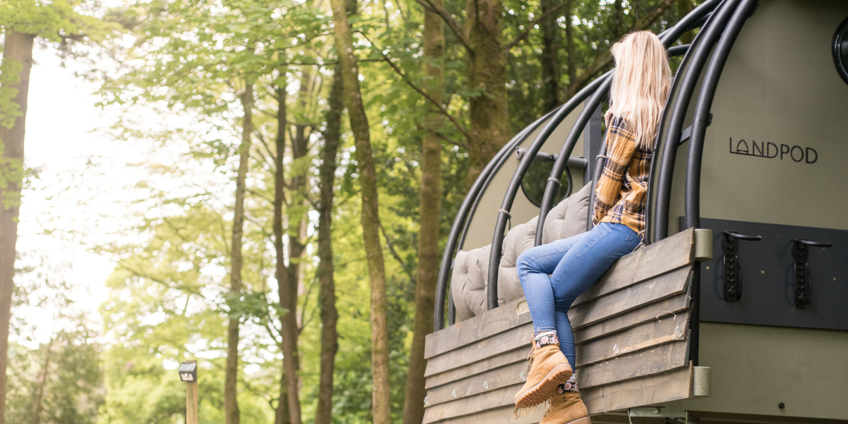 Woman sitting in a Landpod at YHA