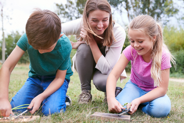 Teacher and children outdoors