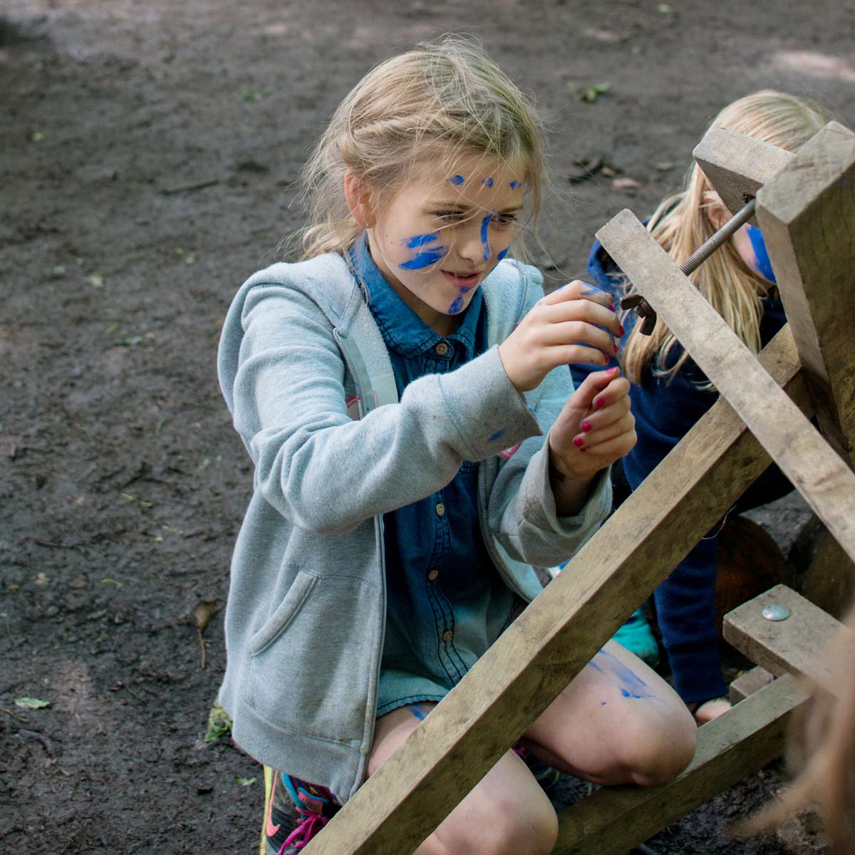 Girl with face painted tying a knot