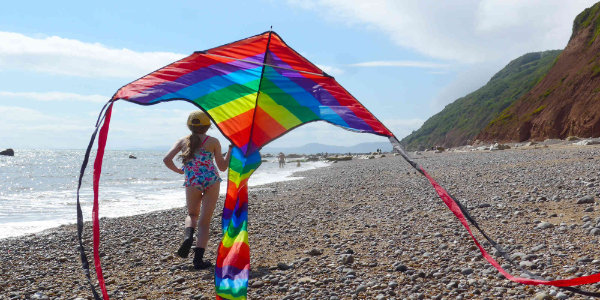 Child flying kite on beach