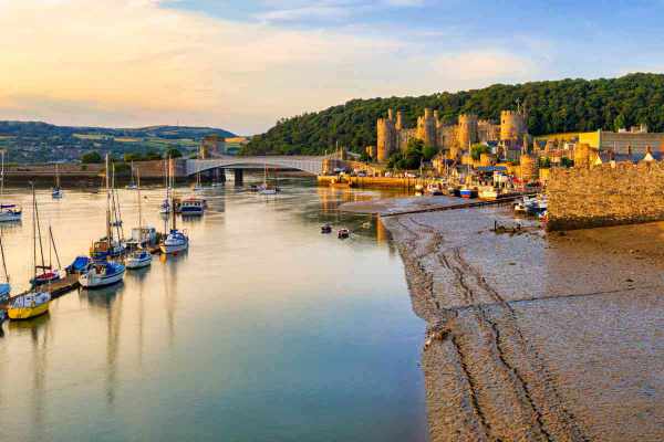 Conwy harbour at sunset with the sky reflected in the water